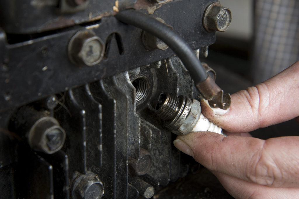 Changing a spark plug in a small gas engine