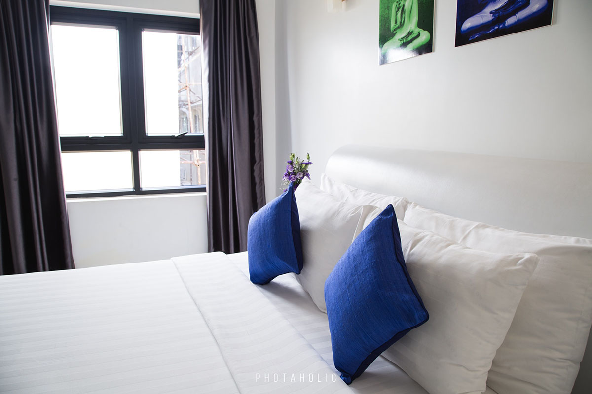 blue throw pillows on a white bed
