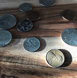 coins sitting on wood