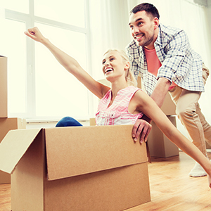 couple playing around with a cardboard box