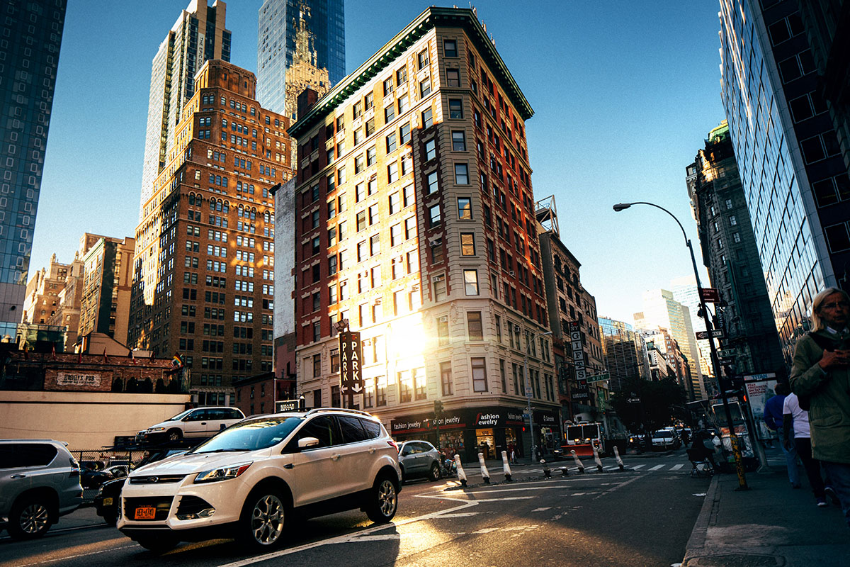 car driving down a busy city street