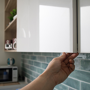 person opening a cabinet