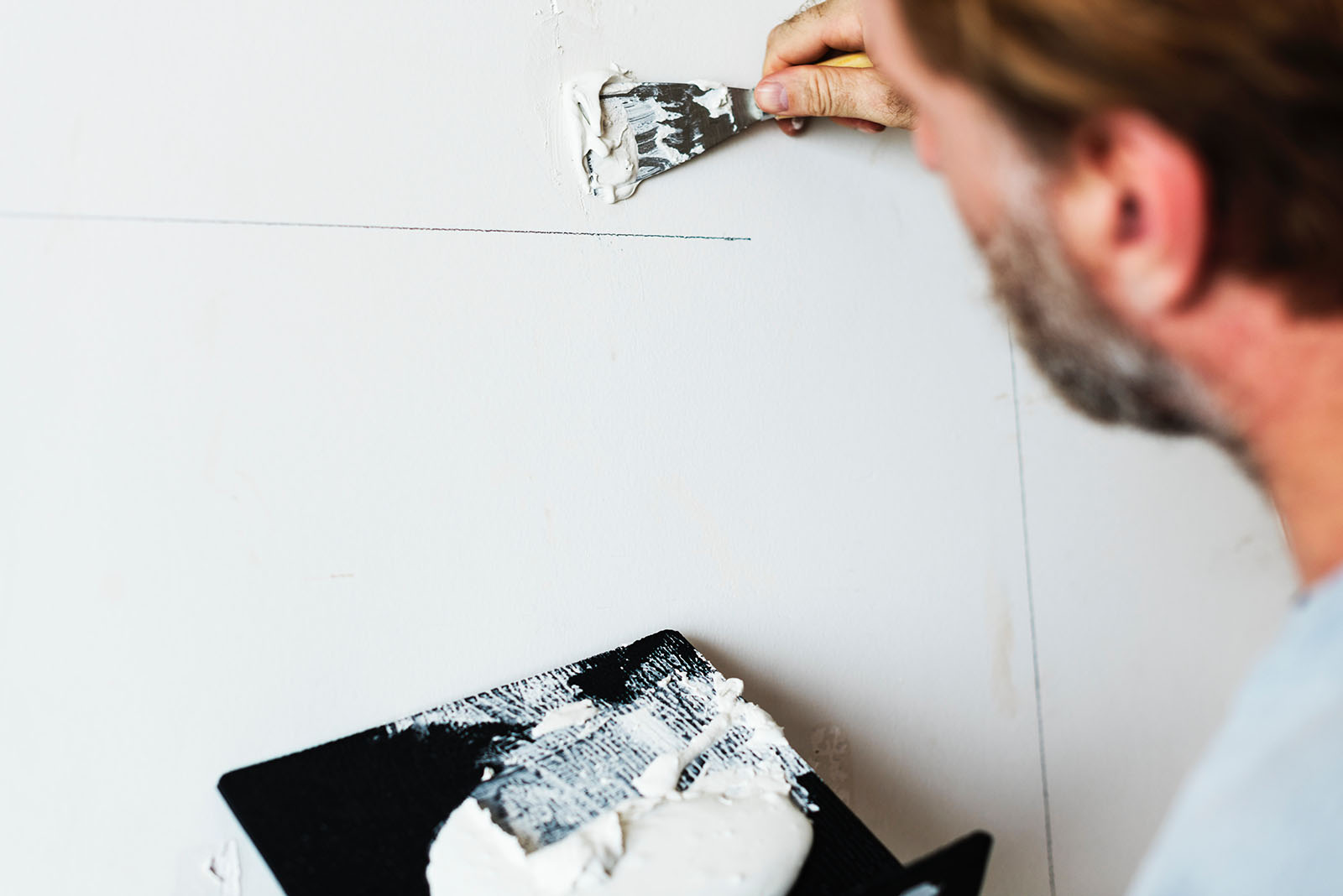 man repairing drywall