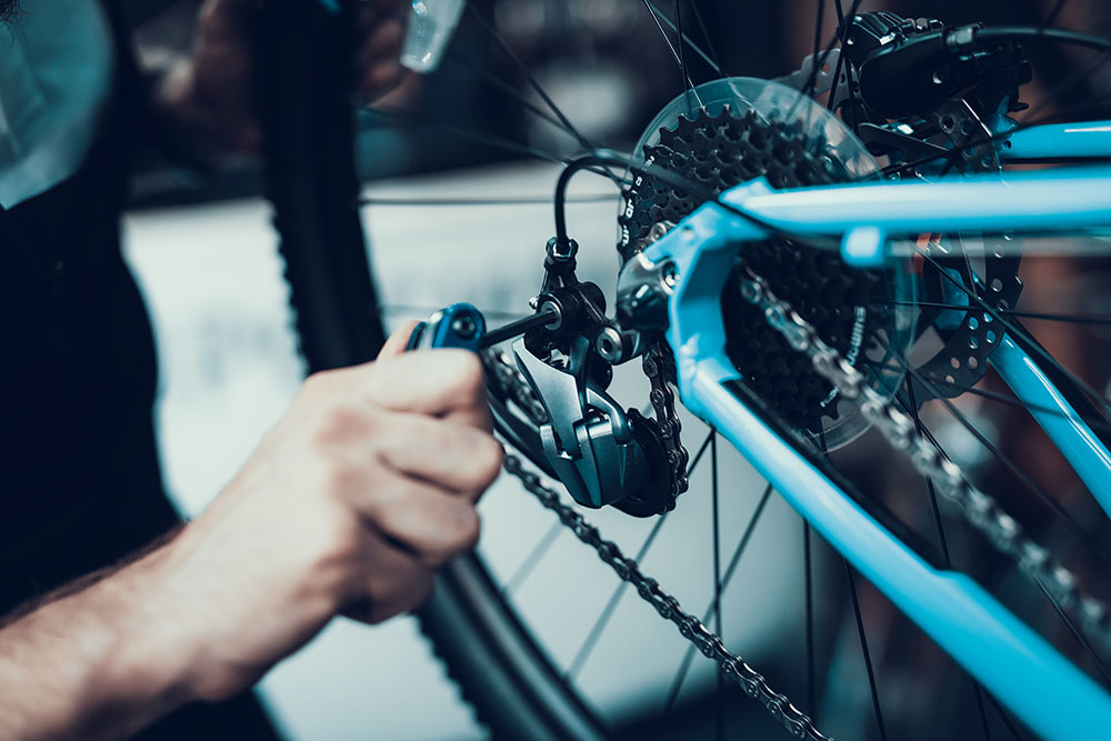 man repairing a derailleur