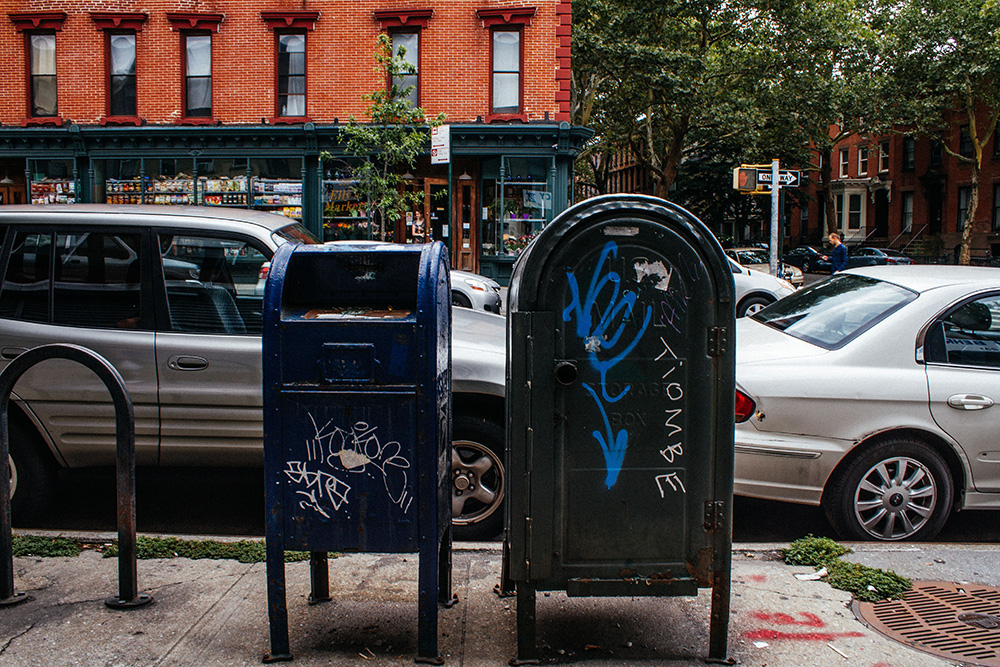 cars parked next to mailboxes