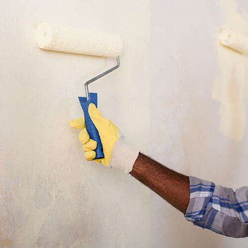 make-ready technician painting a wall
