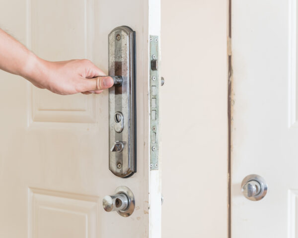 close up of a hand opening a security door