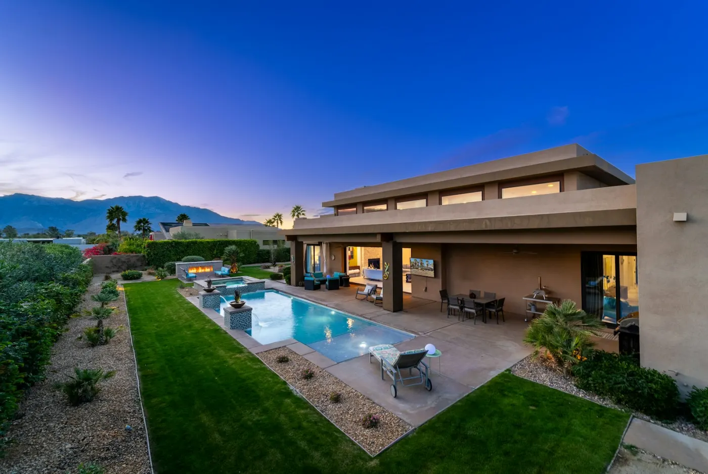 Luxury desert home with a pool at dusk in the Phoenix area