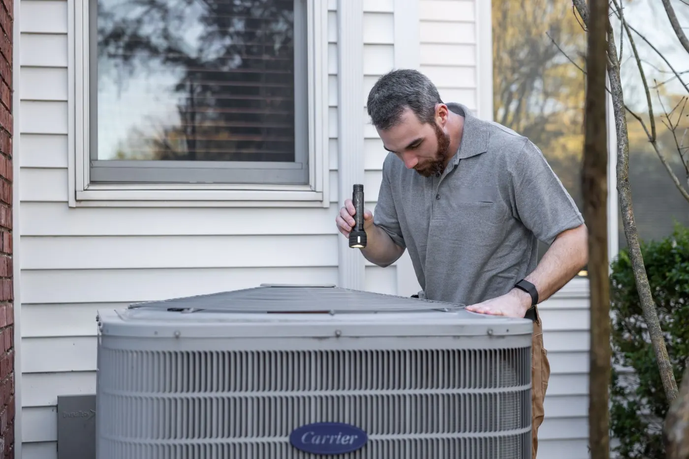 A Lula Pro inspecting an outdoor air conditioning unit at a rental home