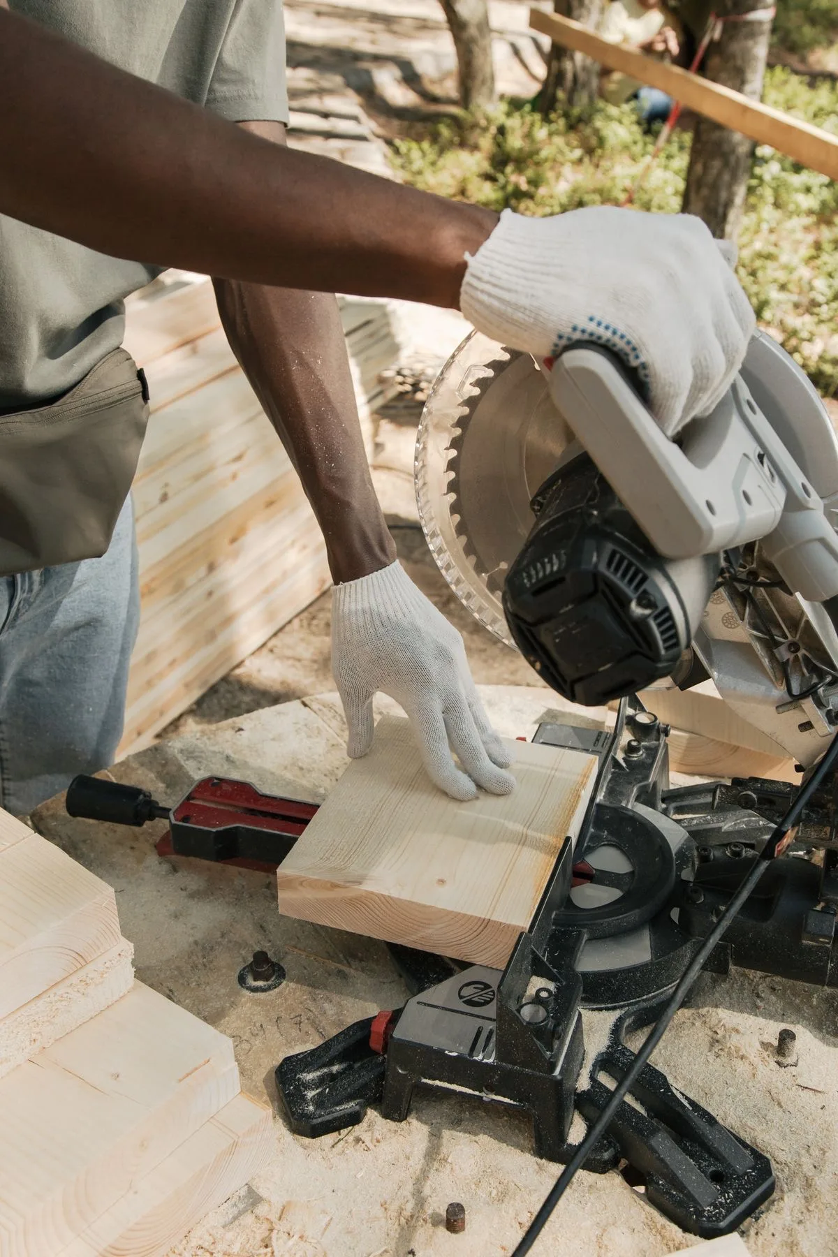 Pro cutting lumber with a power saw outdoors